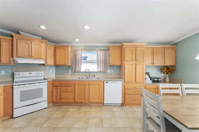 a kitchen with stainless steel appliances granite countertop a stove sink and cabinets