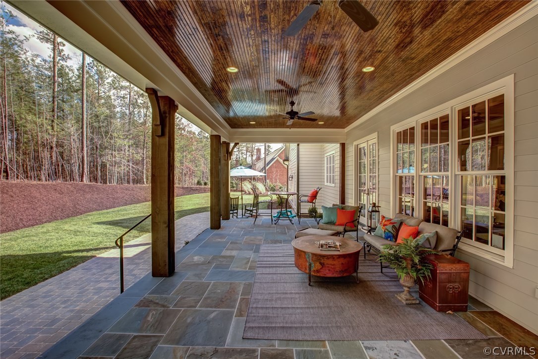 709 Old Stream Road Manakin-Sabot, VA 23103 - Photo 32 of 32 a living room with patio furniture and a garden