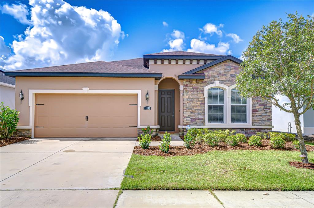 a front view of a house with a yard
