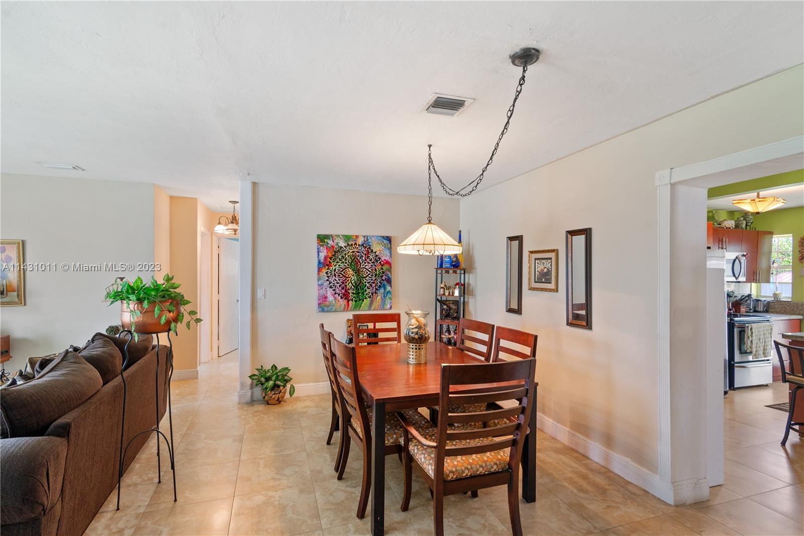 Hialeah Hialeah, FL 33012 - Photo 12 of 40 a dining room with furniture potted plants and a chandelier