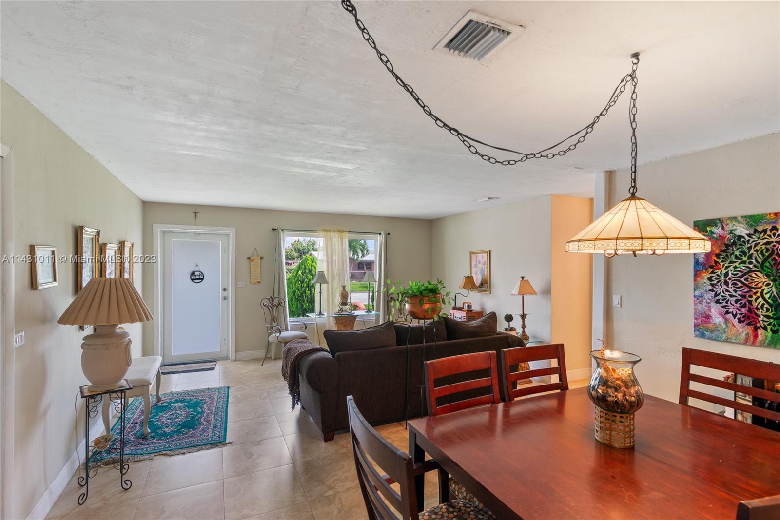 Hialeah Hialeah, FL 33012 - Photo 13 of 40 a living room with furniture dining table and a chandelier