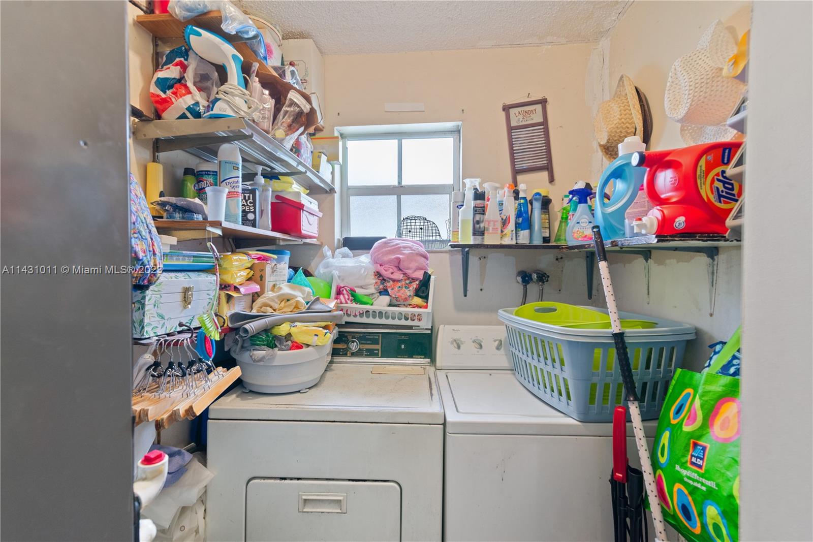 Hialeah Hialeah, FL 33012 - Photo 20 of 40 a utility room with dryer and baby bed