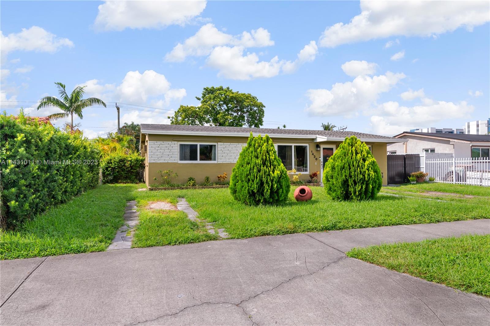 Hialeah Hialeah, FL 33012 - Photo 2 of 40 a front view of house with yard and green space