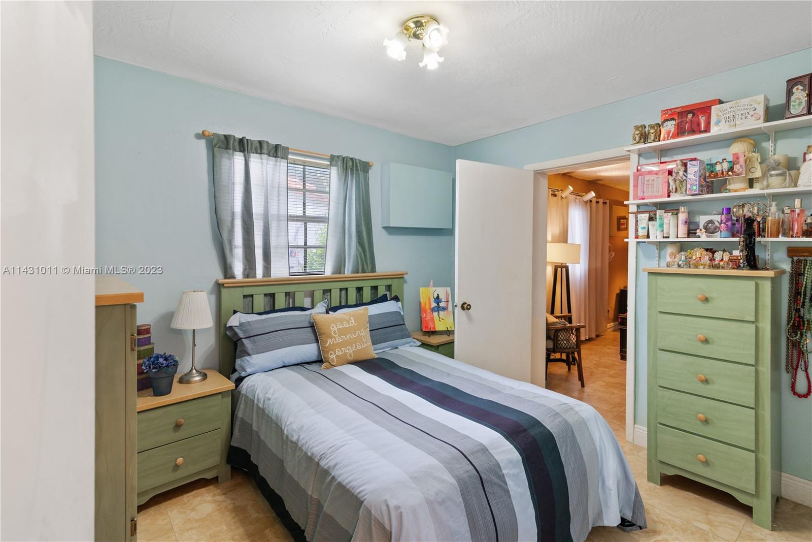 Hialeah Hialeah, FL 33012 - Photo 23 of 40 a bedroom with a bed and a cabinets