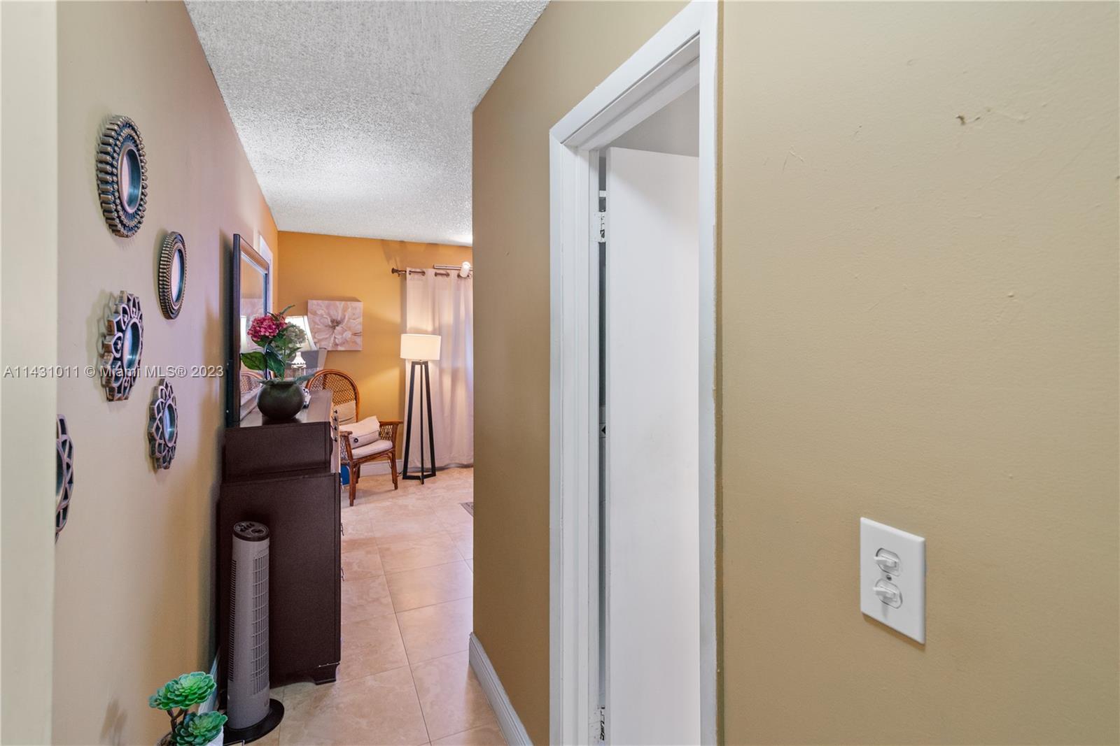 Hialeah Hialeah, FL 33012 - Photo 24 of 40 a view of a hallway with paintings on the wall