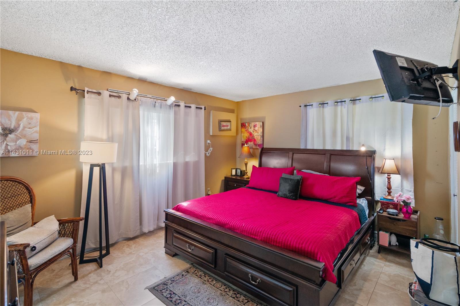 Hialeah Hialeah, FL 33012 - Photo 26 of 40 a bed room with a bed chair and a window