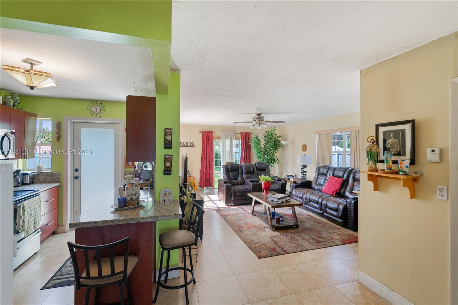 Hialeah Hialeah, FL 33012 - Photo 5 of 40 a living room with fireplace furniture and a large window
