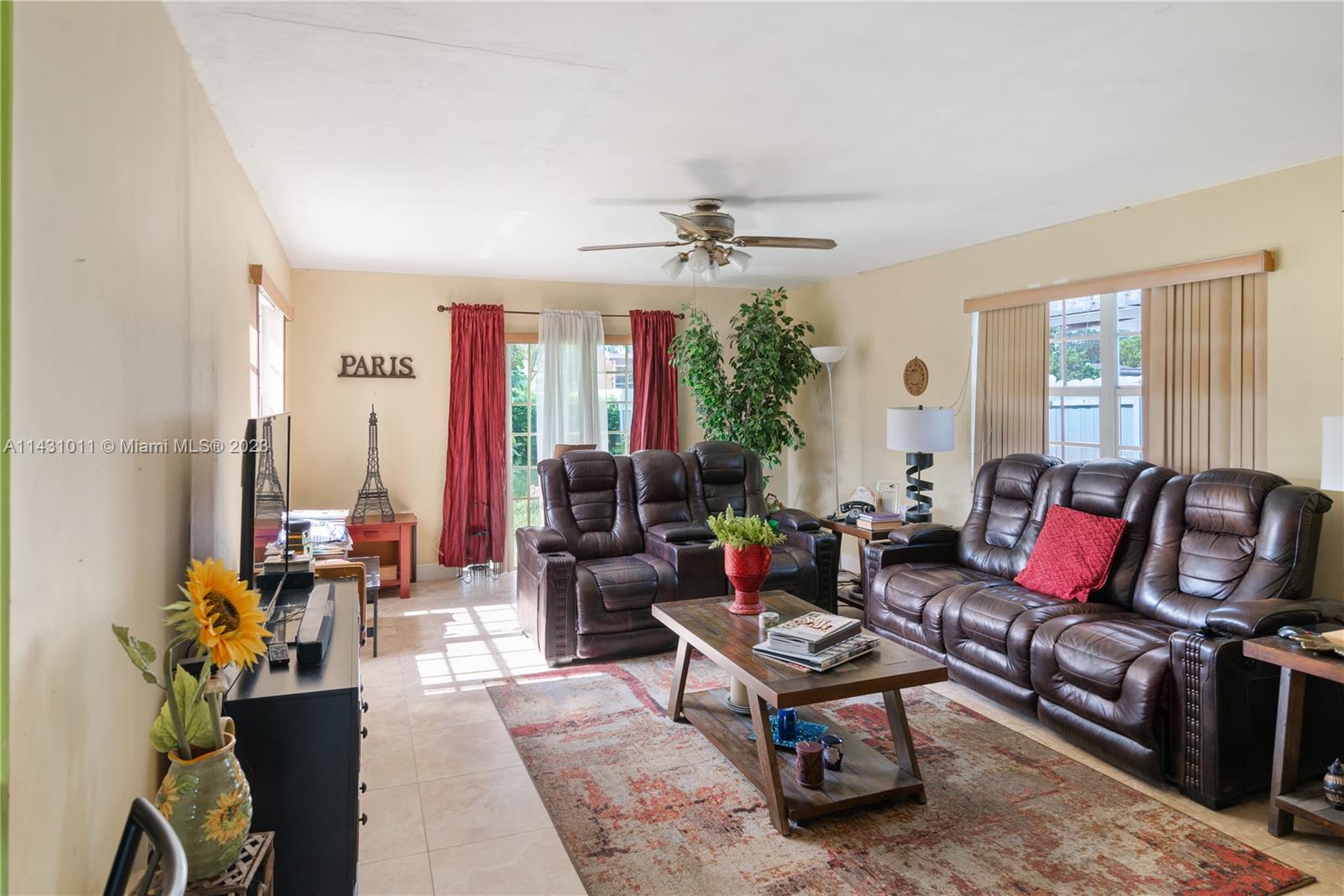 Hialeah Hialeah, FL 33012 - Photo 6 of 40 a living room with furniture a chandelier and a table