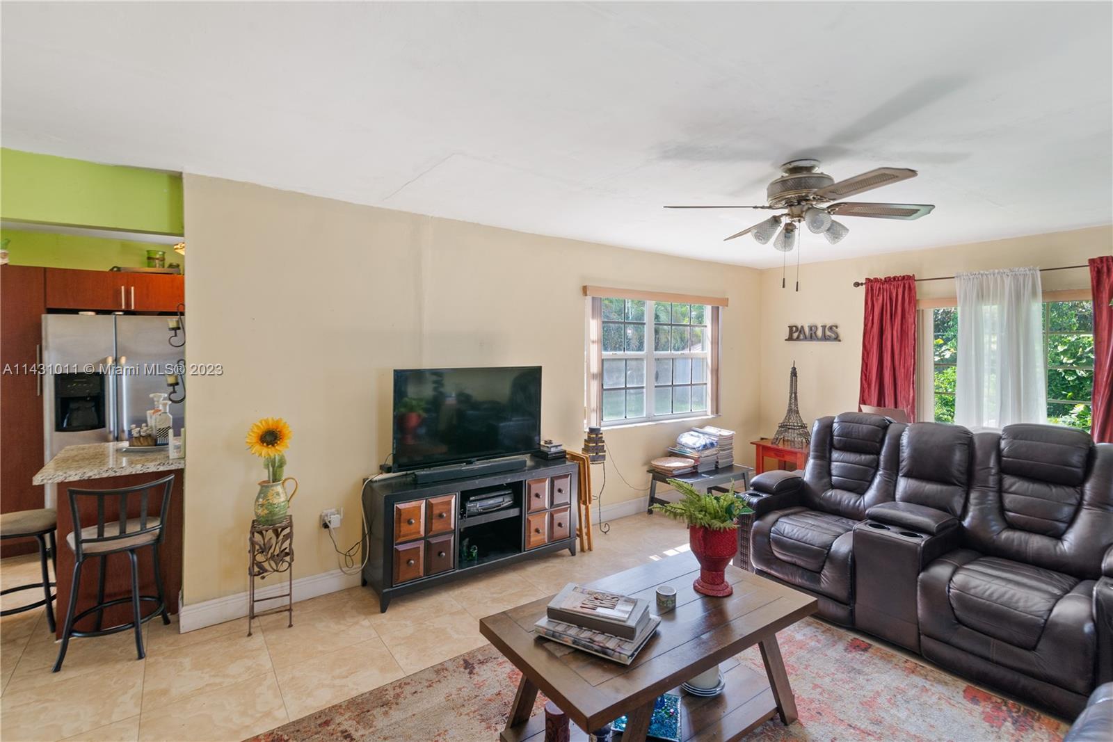 Hialeah Hialeah, FL 33012 - Photo 7 of 40 a living room with furniture a fireplace and a flat screen tv