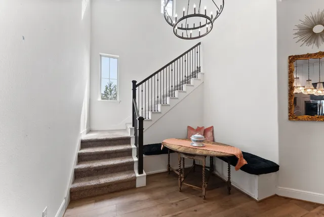 a living room with furniture and a chandelier