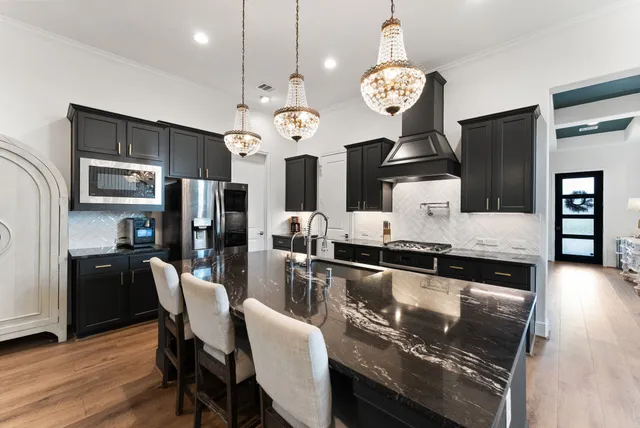a living room with furniture kitchen view and a fireplace