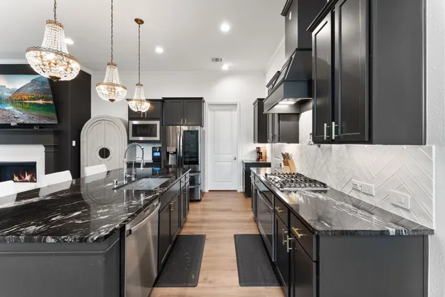 a view of a kitchen with dining table and chairs