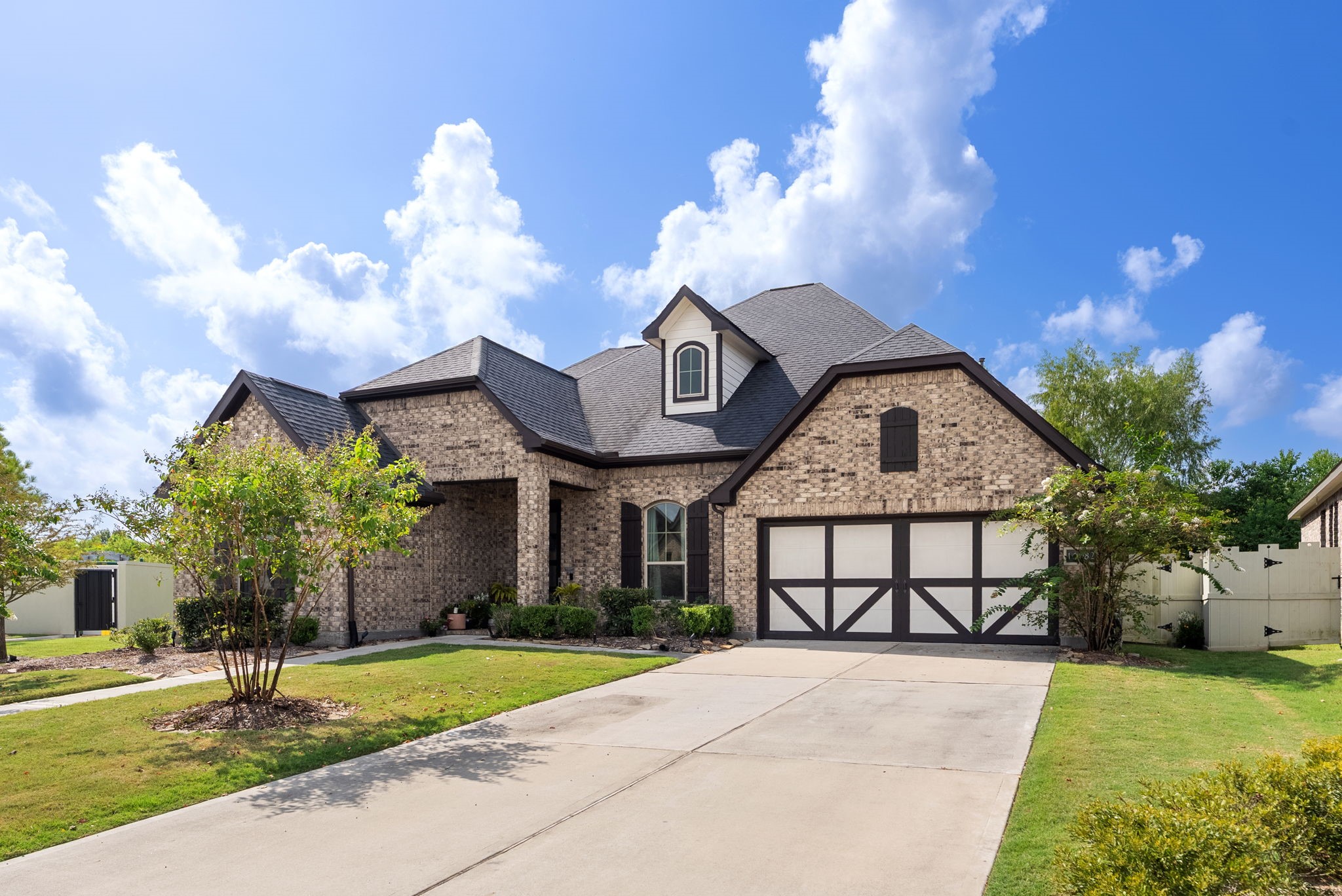 10082 Preserve Way Conroe, TX 77385 - Photo 2 of 47 a front view of a house with garden