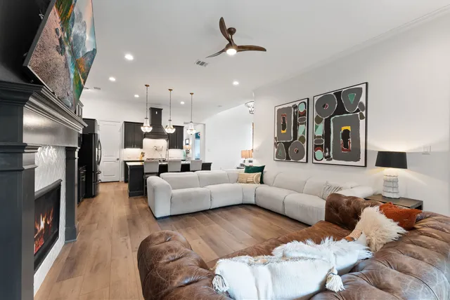 a en suite bathroom with a tub double vanity and a large mirror