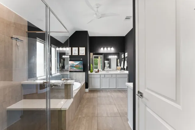 a bathroom with a double vanity sink toilet and a mirror