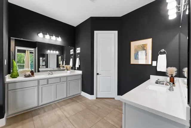 a living room with furniture and a baby crib