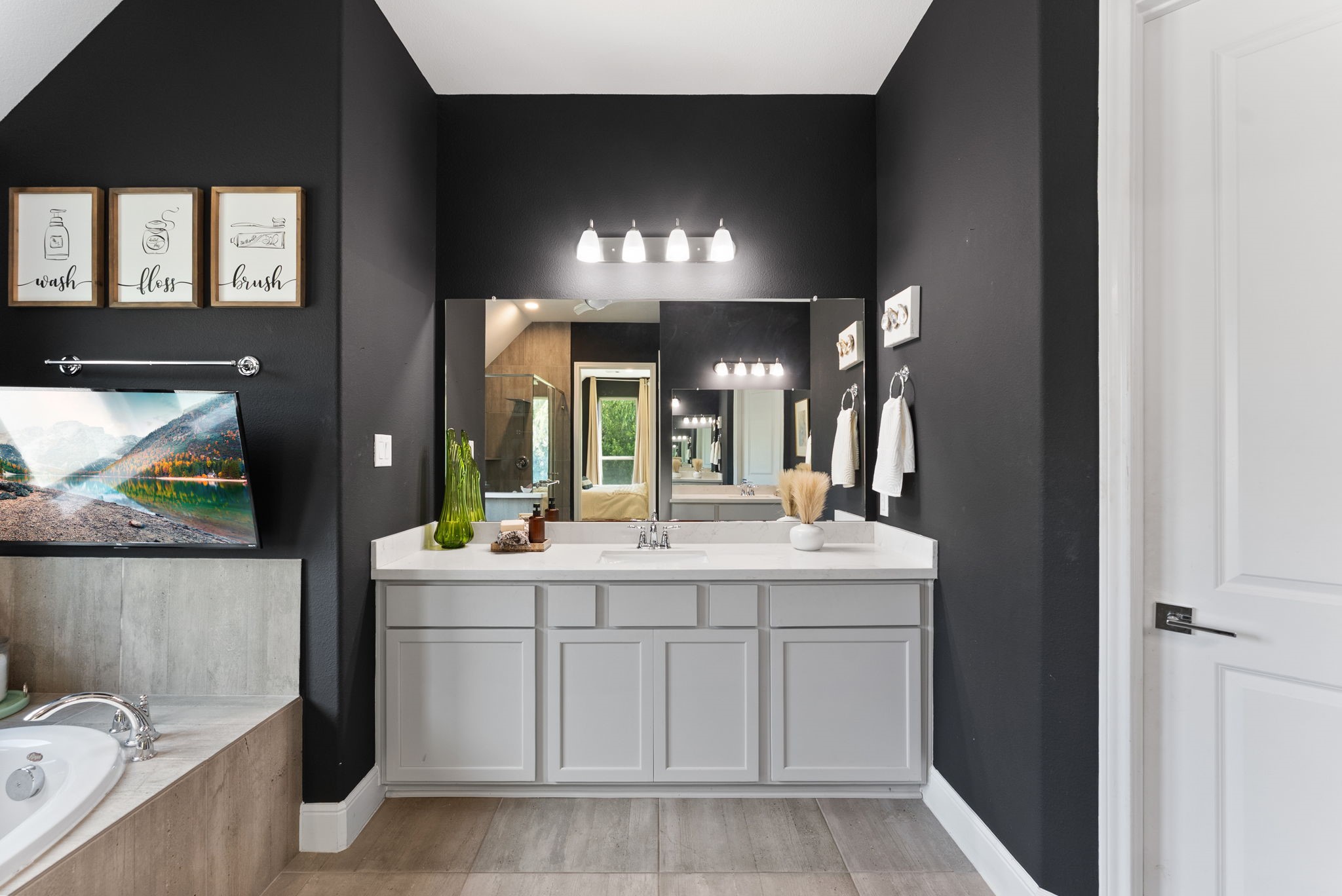 10082 Preserve Way Conroe, TX 77385 - Photo 32 of 47 a bathroom with a sink vanity and mirror