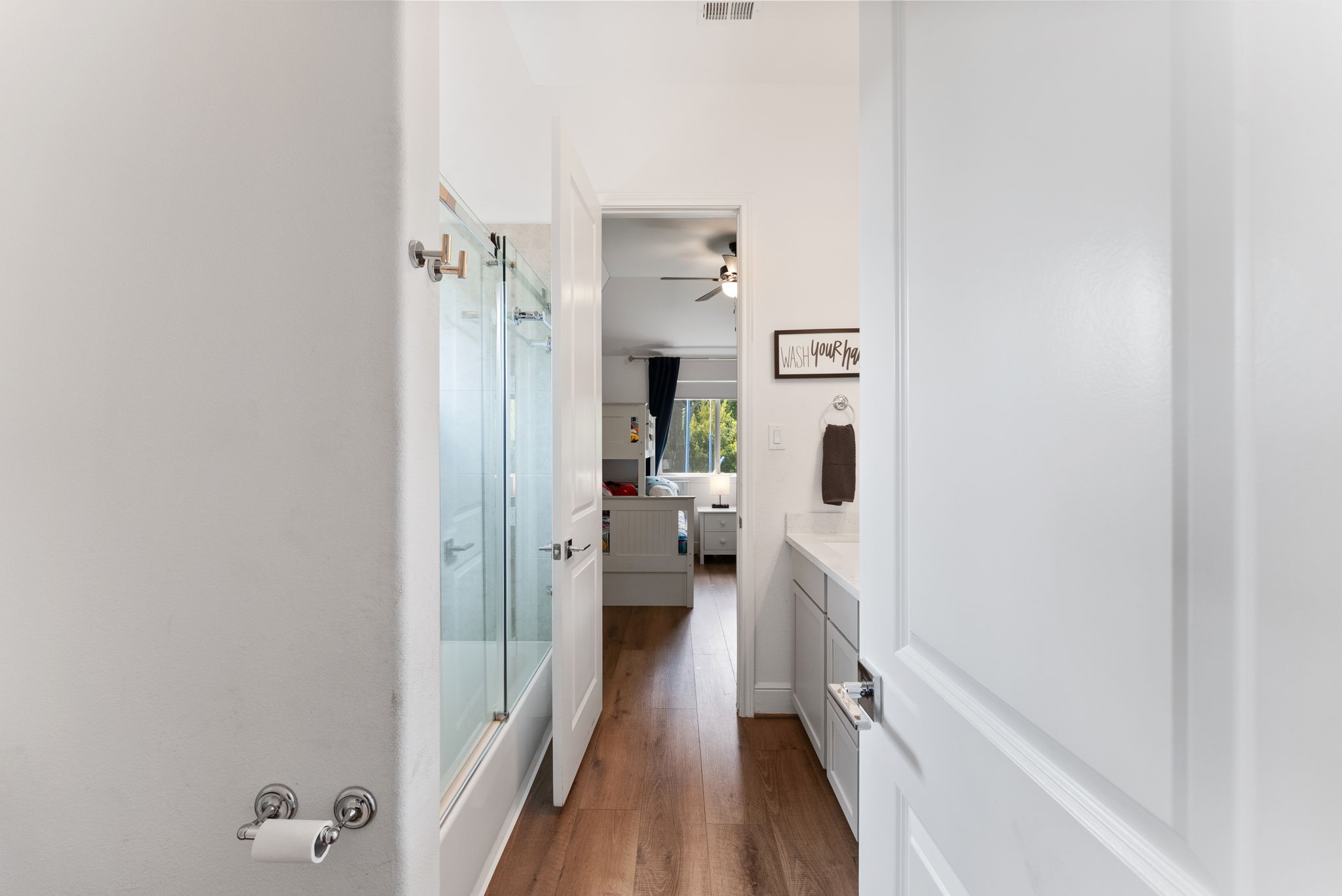 10082 Preserve Way Conroe, TX 77385 - Photo 35 of 47 Convenient bathroom with dual vanities and modern fixtures, connecting the two secondary bedrooms on the first floor.