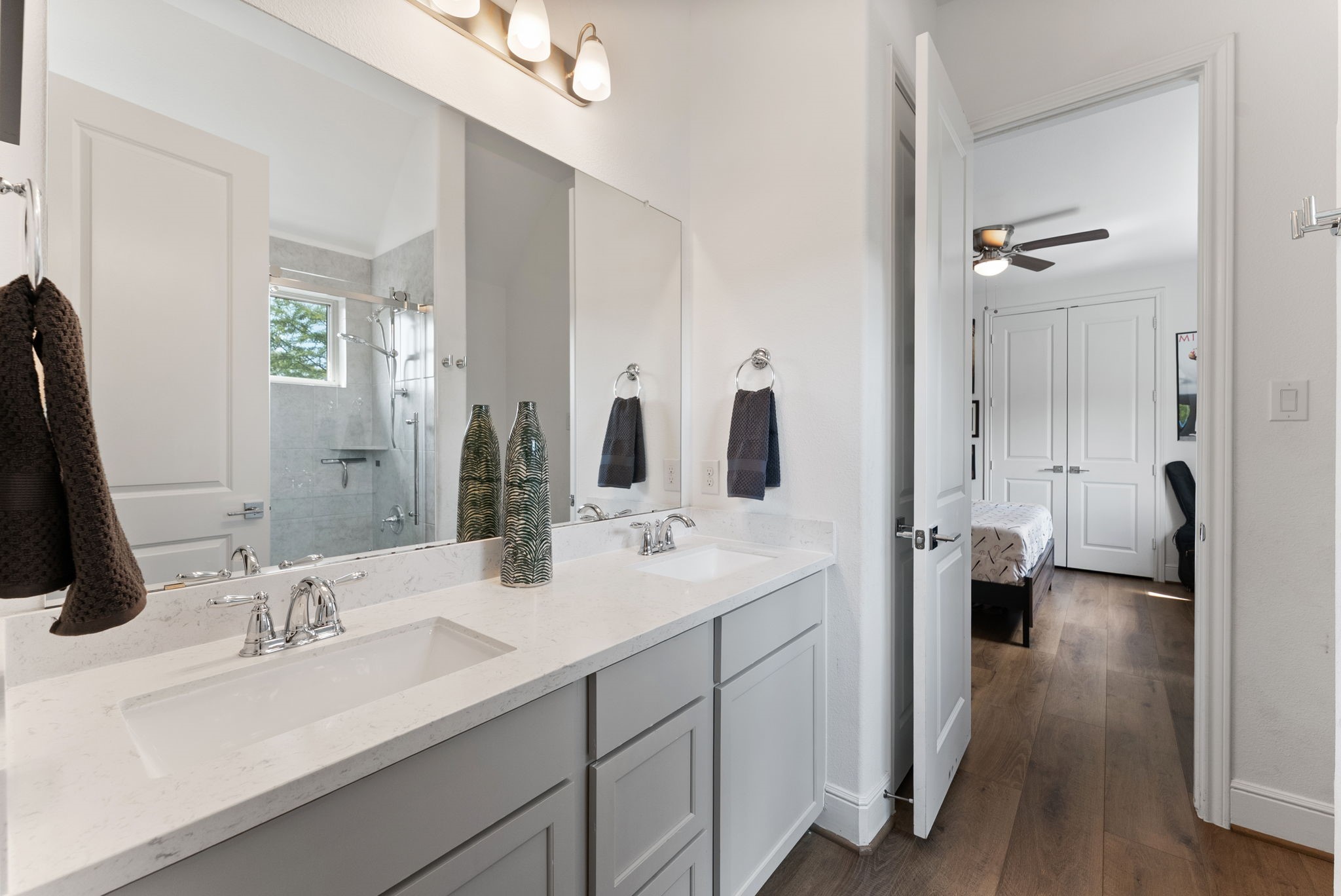 10082 Preserve Way Conroe, TX 77385 - Photo 36 of 47 a bathroom with a double vanity sink toilet and a mirror