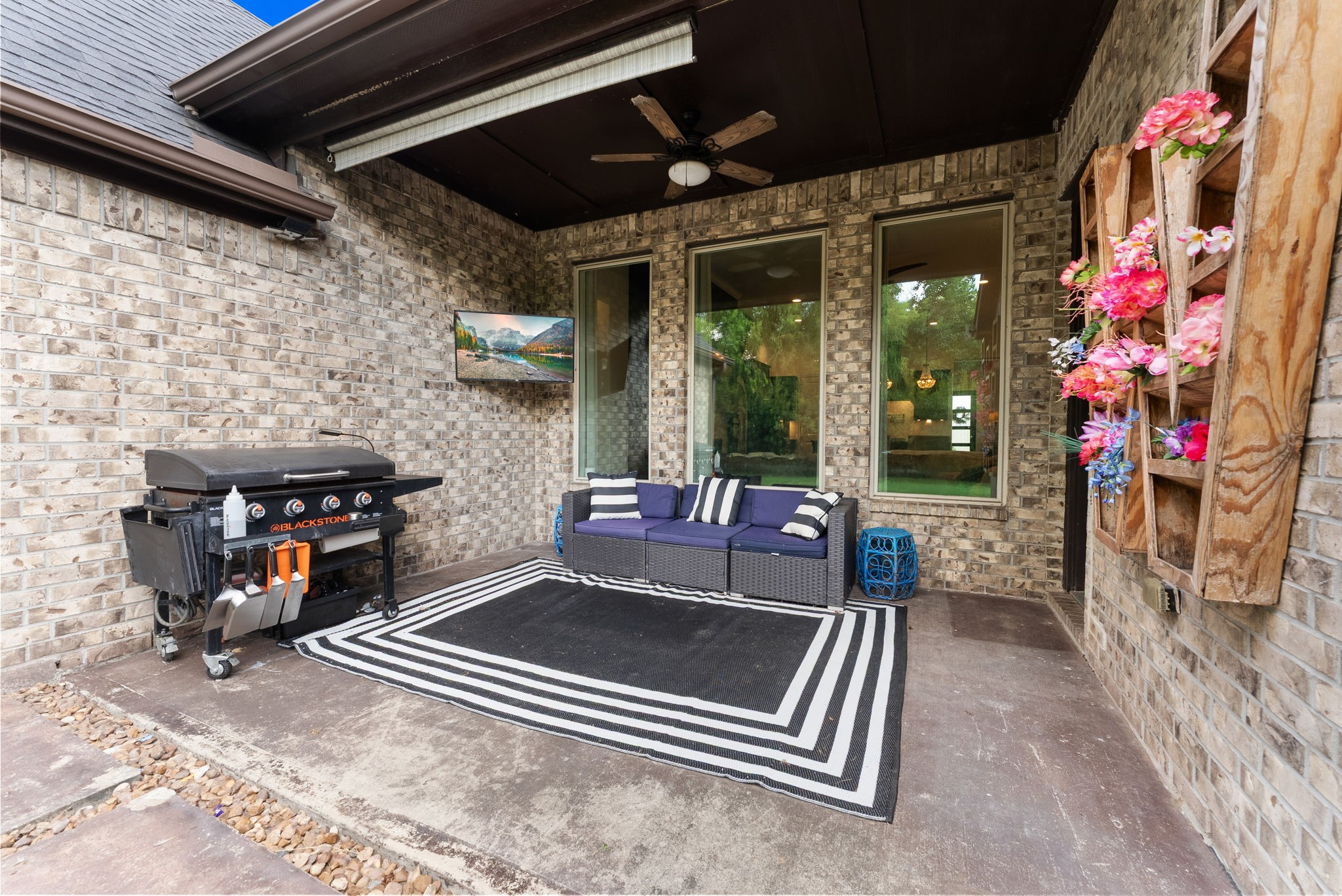 10082 Preserve Way Conroe, TX 77385 - Photo 44 of 47 Covered patio with ceiling fan, ideal for grilling and outdoor living.