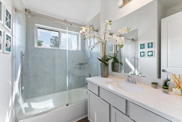 a bathroom with a shower sink and mirror