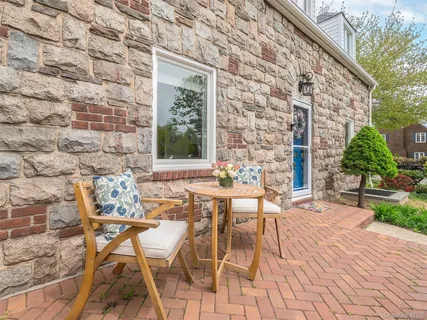 a view of a patio with a table and chairs