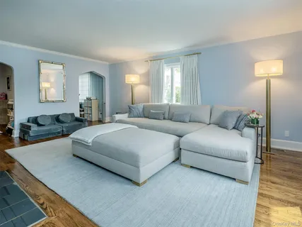 a bedroom with a bed couch and window