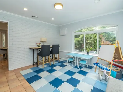 a work room with furniture and a rug