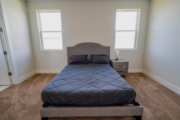 a bedroom with a bed and window