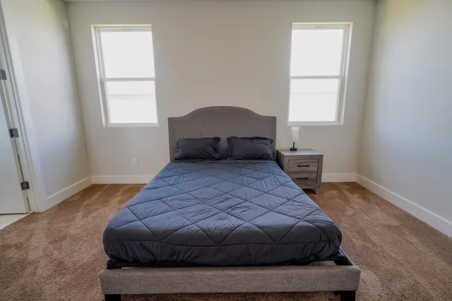 a bedroom with a bed and window