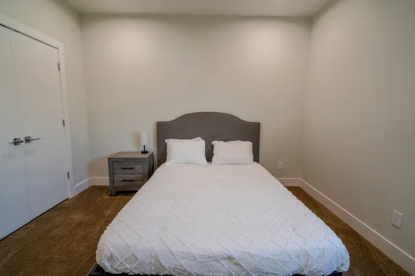 a bedroom with a bed and window