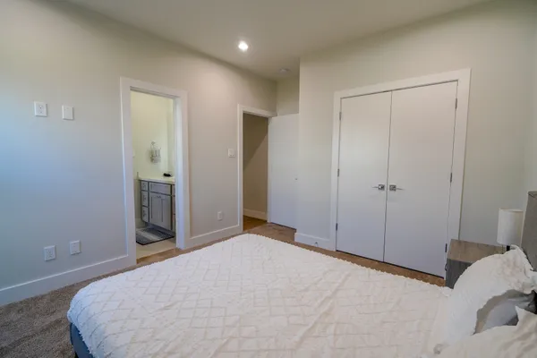 a bedroom with a bed and a shower