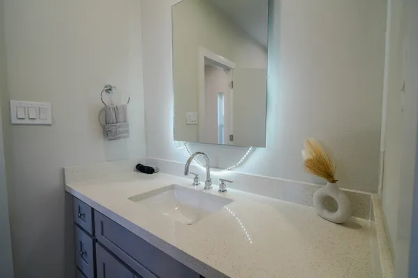 a bathroom with a sink and a mirror