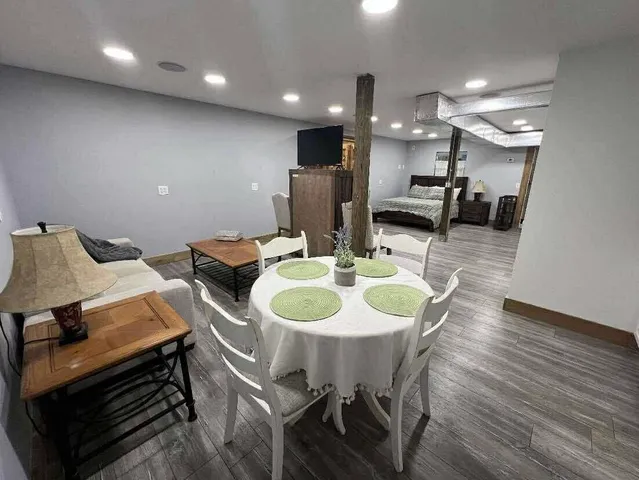 a view of a dining room with furniture and wooden floor