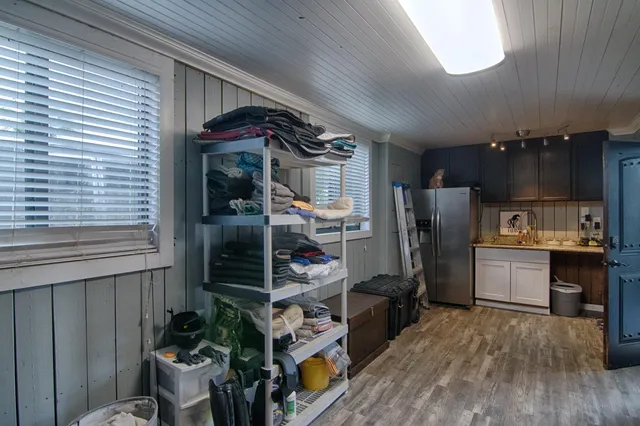 a kitchen with stainless steel appliances kitchen island granite countertop a refrigerator a stove a sink and dishwasher