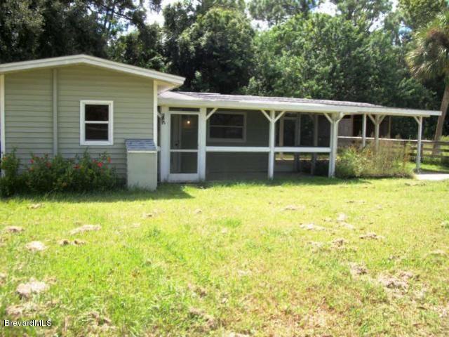 2740 Turtle Mound Road Melbourne, FL 32934 - Photo 10 of 16 a front view of a house with a yard