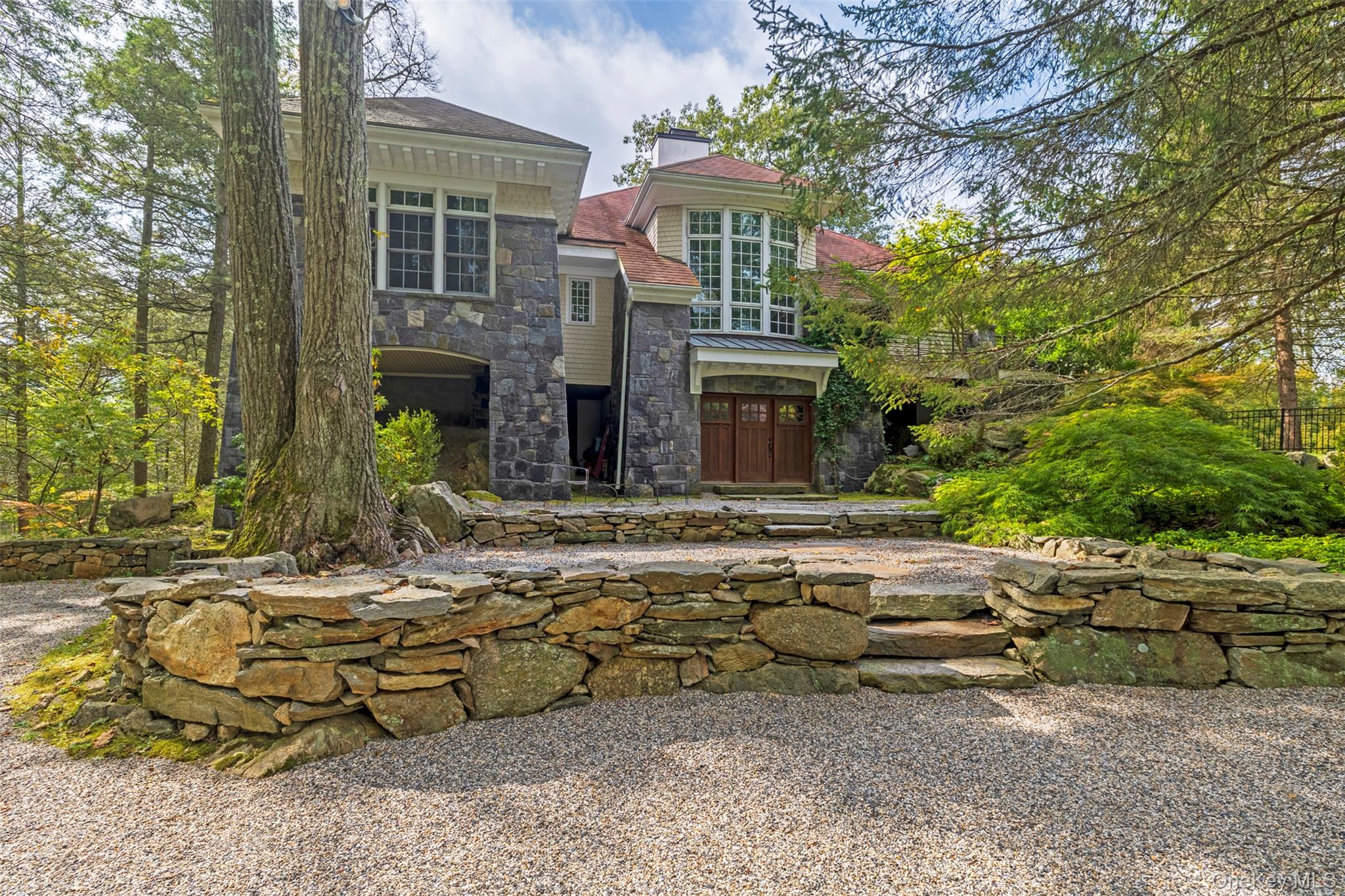 12 Bishop Park Road Pound Ridge, NY 10576 - Photo 2 of 49 a view of backyard of house with outdoor seating area and trees