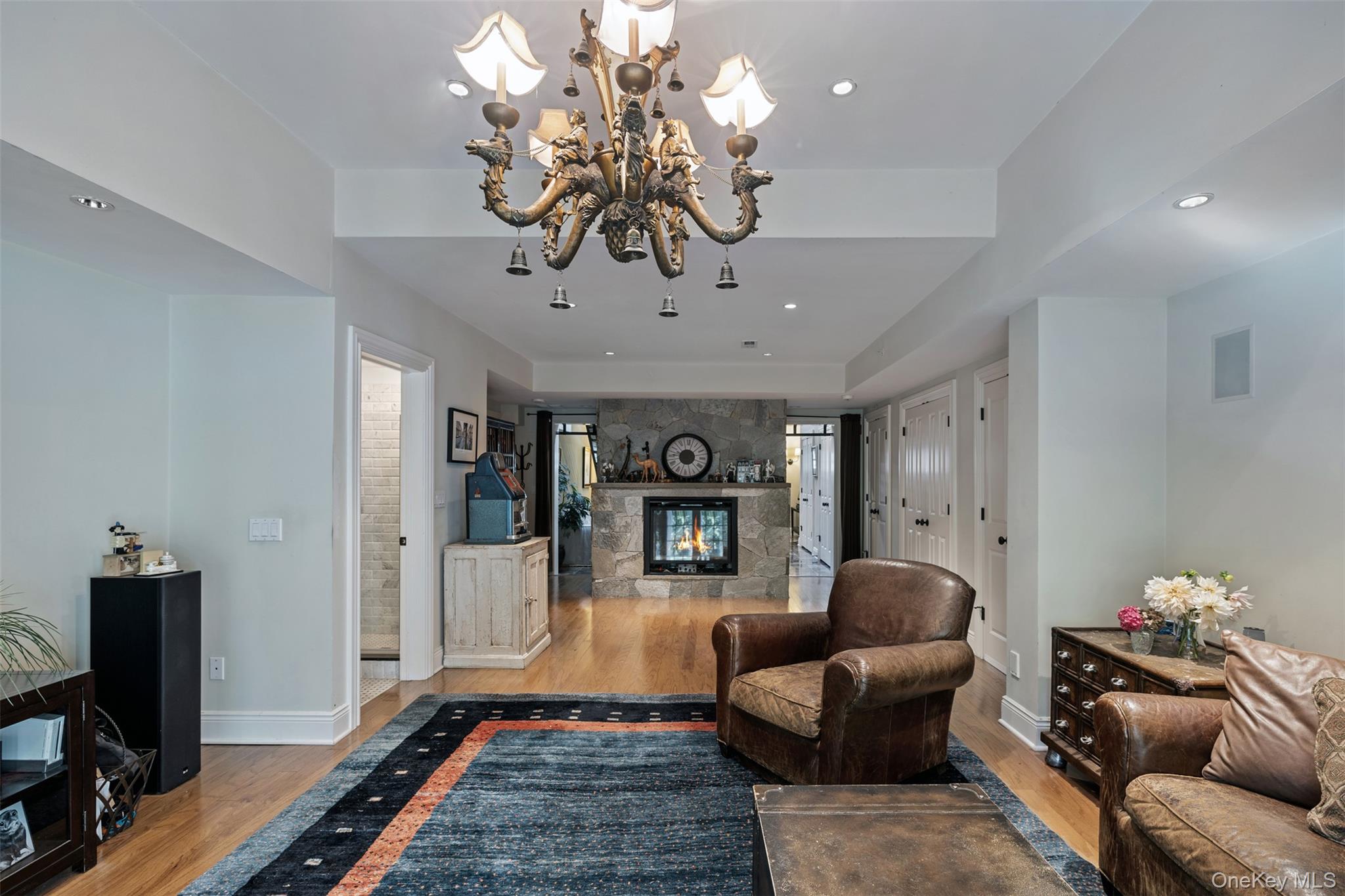 12 Bishop Park Road Pound Ridge, NY 10576 - Photo 26 of 49 a living room with furniture and a chandelier