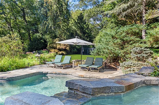 a view of patio with table and chairs under an umbrella