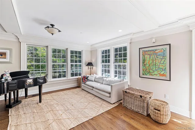 a living room with furniture and floor to ceiling windows