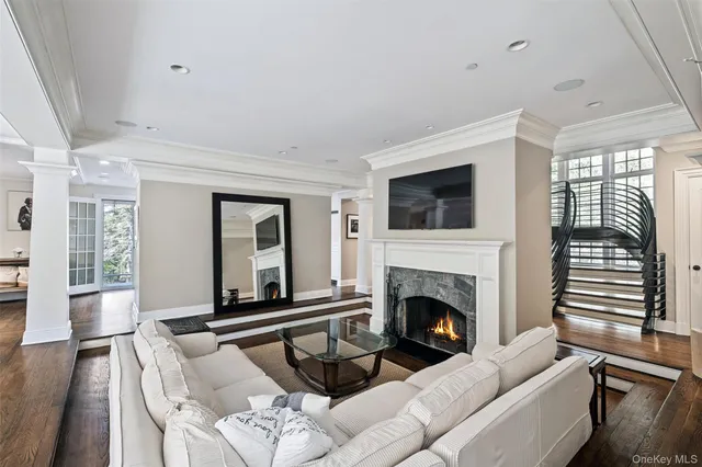 a living room with furniture fireplace and flat screen tv