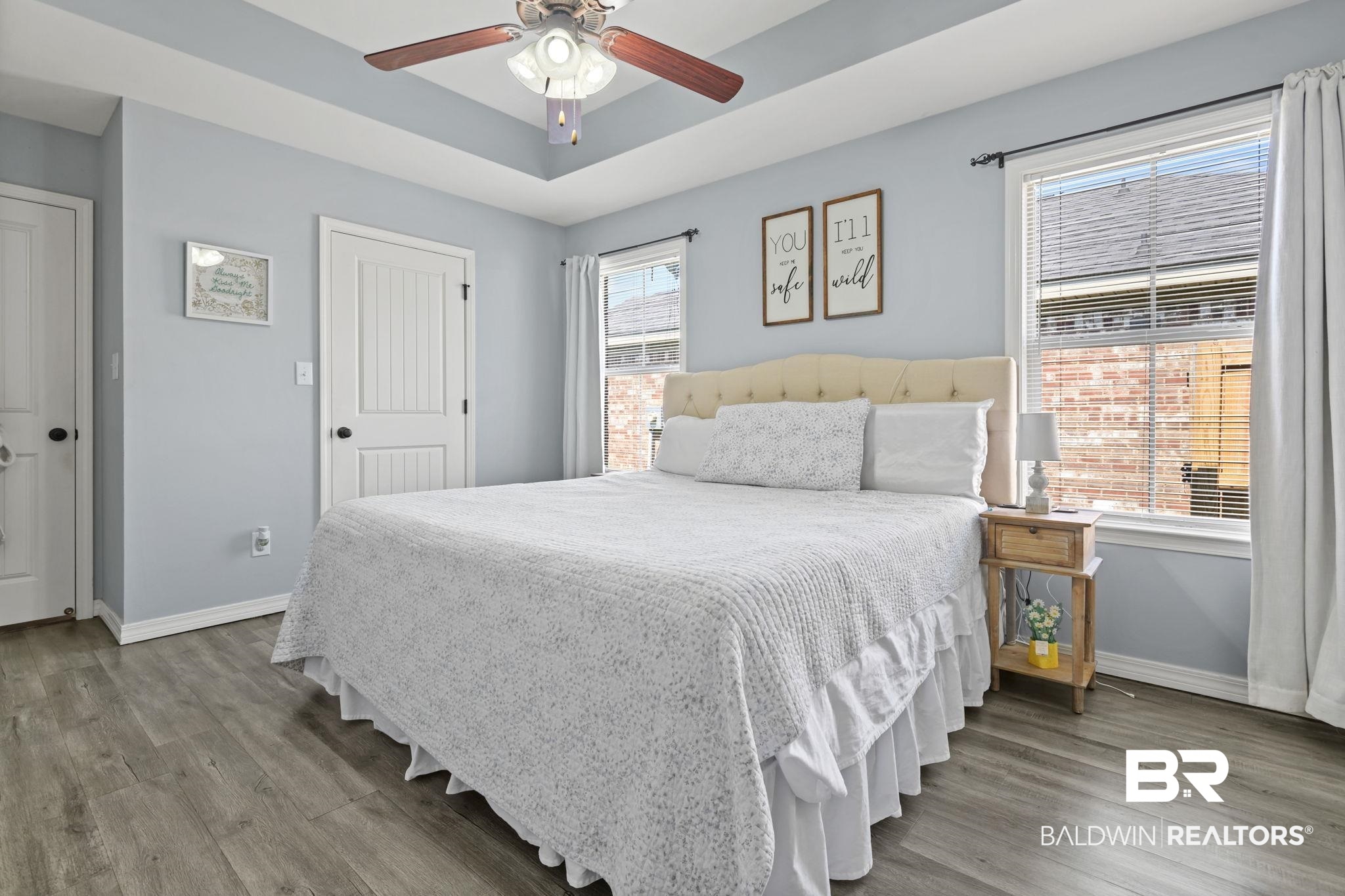 8956 Spring Grove North Mobile, AL 36695 - Photo 10 of 19 Bedroom with baseboards, wood finished floors, a tray ceiling, and ceiling fan