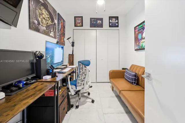 a bedroom with furniture and a desk