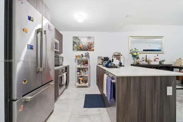 a kitchen with a refrigerator and a sink