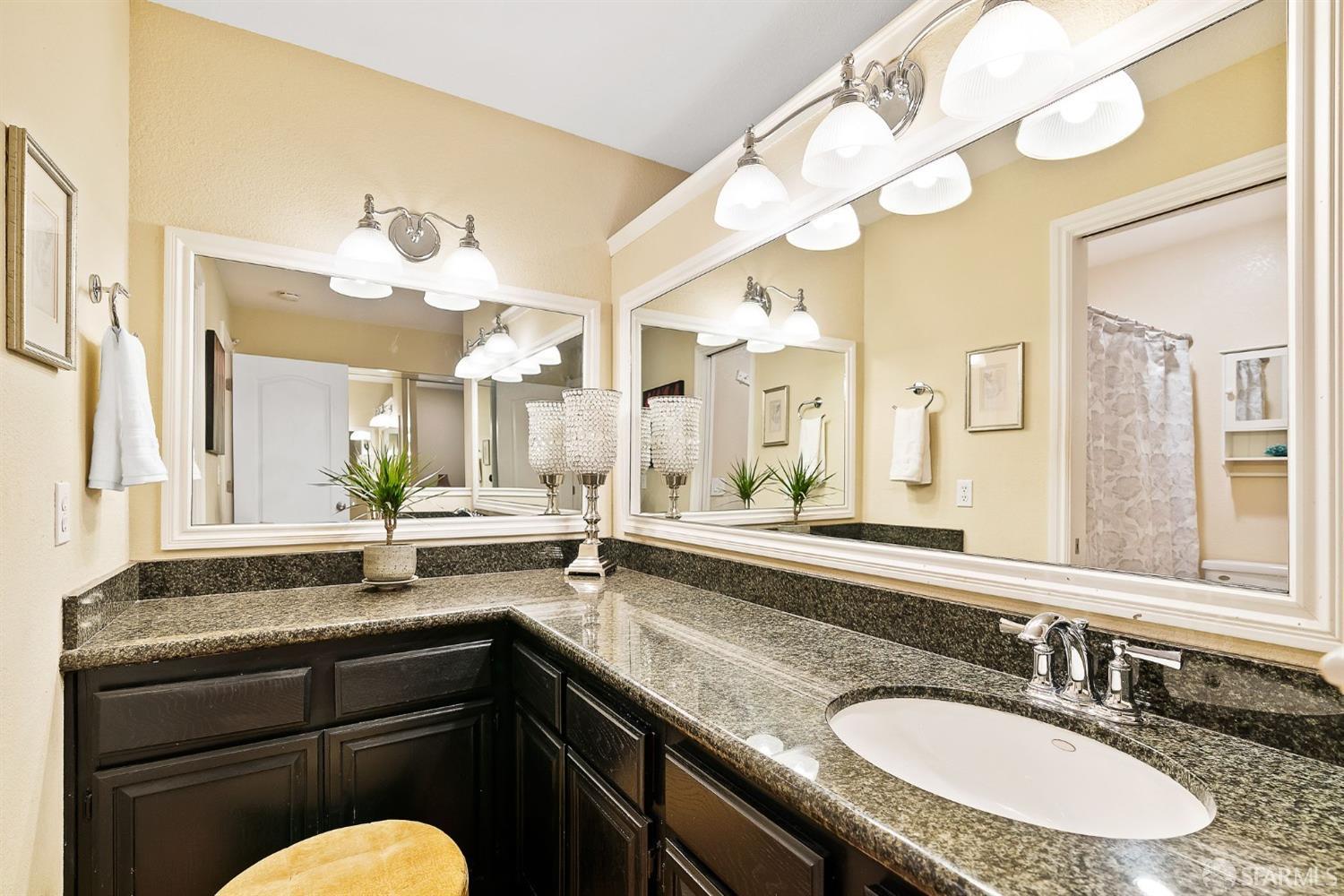 348 Mill Road Martinez, CA 94553 - Photo 14 of 28 a bathroom with a granite countertop sink and a mirror
