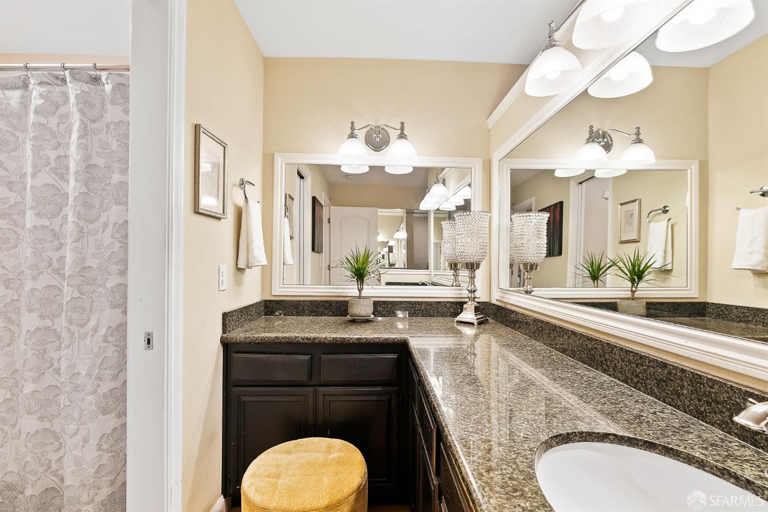 348 Mill Road Martinez, CA 94553 - Photo 15 of 28 a bathroom with a granite countertop sink a toilet and a mirror