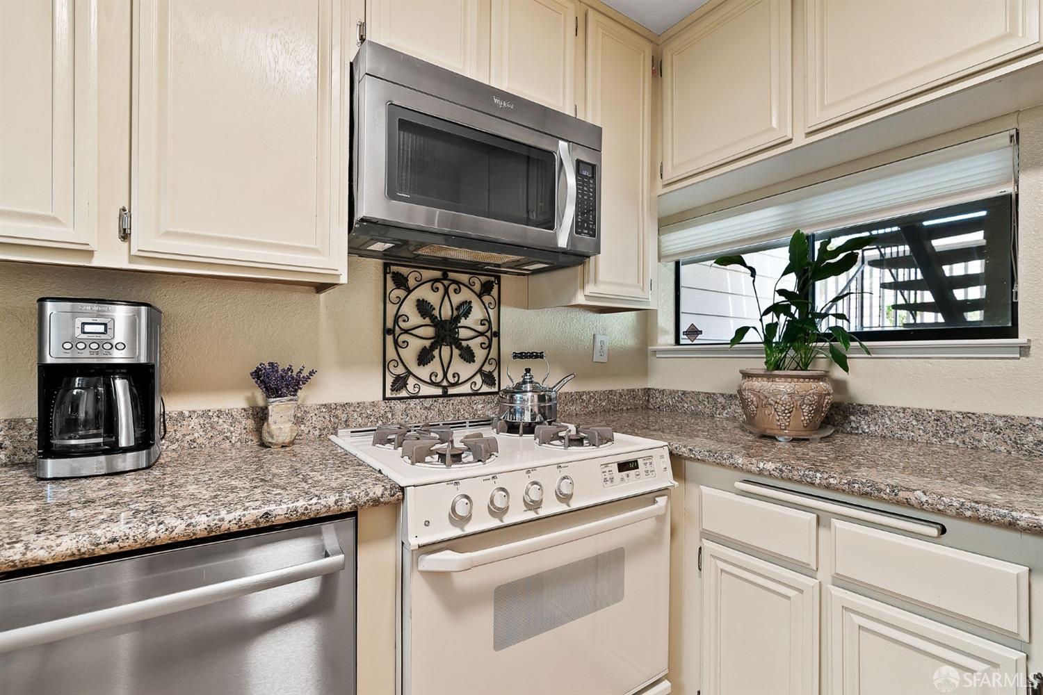 348 Mill Road Martinez, CA 94553 - Photo 7 of 28 a kitchen with kitchen island granite countertop a sink a stove and cabinets