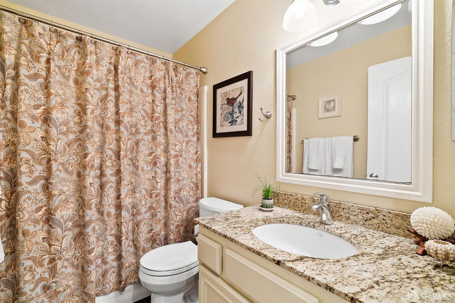 348 Mill Road Martinez, CA 94553 - Photo 10 of 28 a bathroom with a granite countertop sink and a mirror