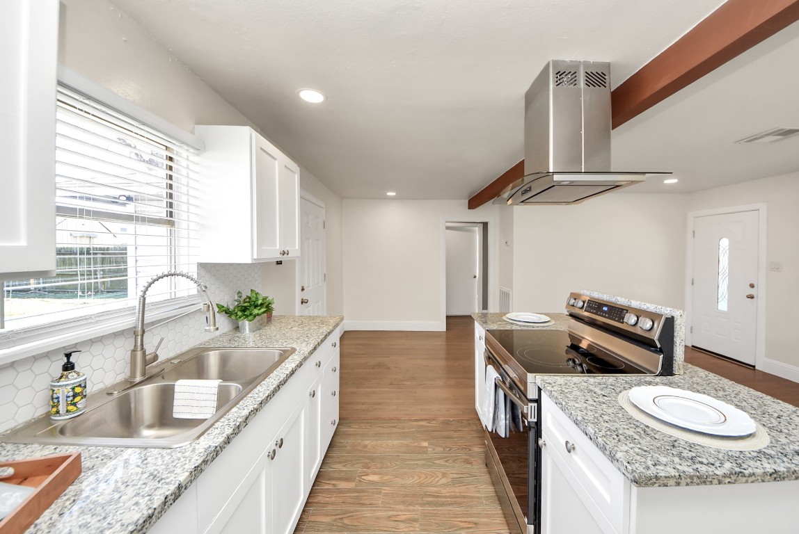 119 Burke Road Pasadena, TX 77506 - Photo 14 of 47 a kitchen with granite countertop a sink and a stove