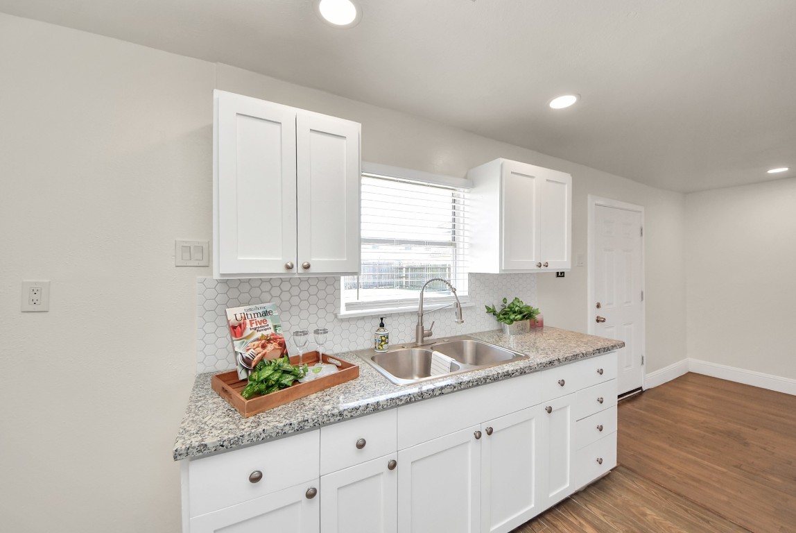 119 Burke Road Pasadena, TX 77506 - Photo 16 of 47 a kitchen with granite countertop white cabinets white appliances and a sink